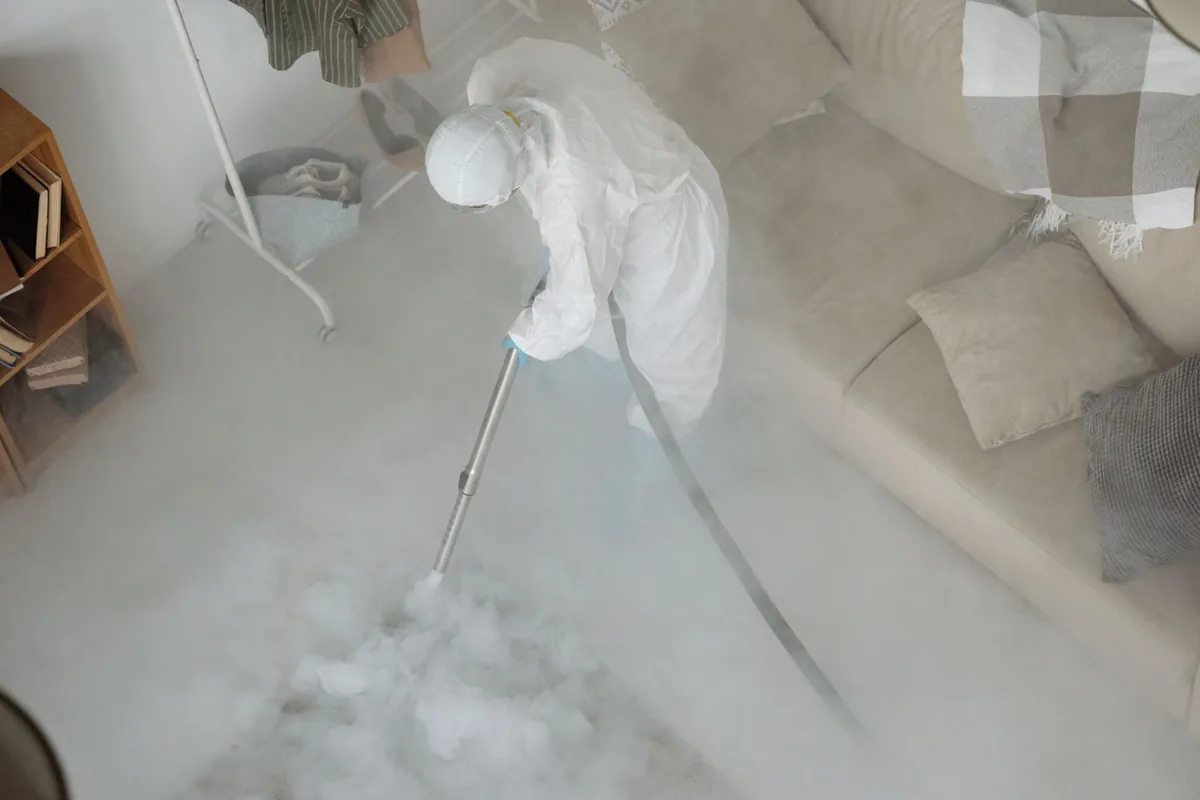 Biohazard cleanup technician in protective equipment, Newton, MA